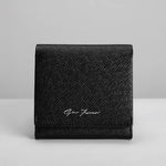 A black textured leather wallet with a silver-tone 'Gino Ferrari' signature logo on the front, set against a clean light-grey background.