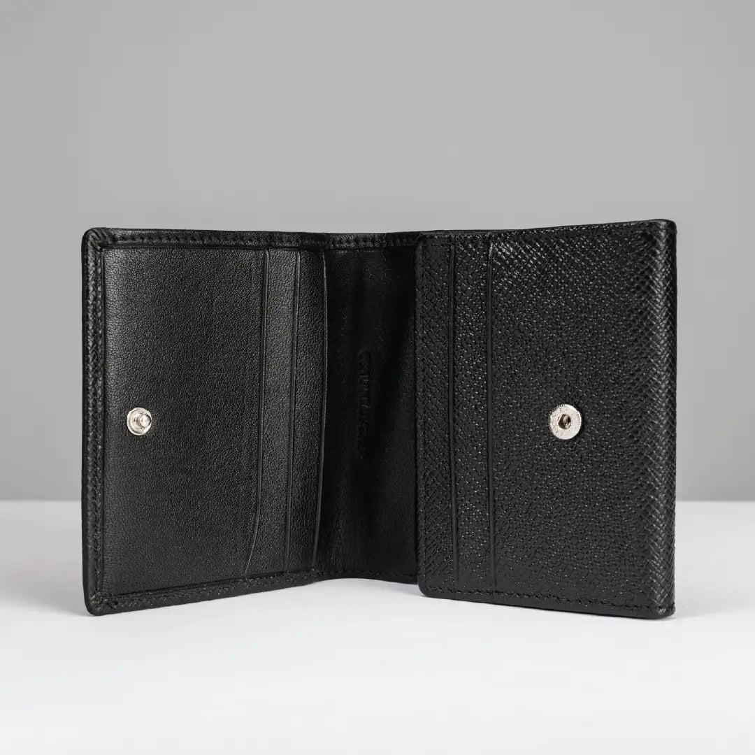 An open black leather bi-fold wallet with a textured exterior and silver snap buttons, displayed against a neutral gray background.