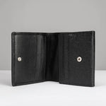 An open black leather bi-fold wallet with a textured exterior and silver snap buttons, displayed against a neutral gray background.