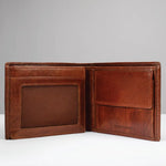 An open brown leather bi-fold wallet with multiple card slots, a slip pocket, and an ID window, shown against a neutral gray background.