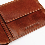 A close-up of a brown leather wallet showing the interior card slots and a debossed brand name that reads 'Genuine Leather'.