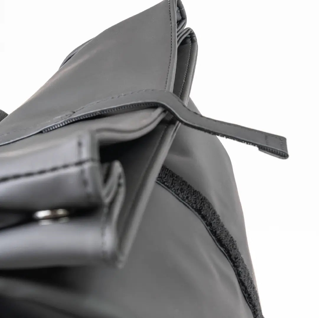 Close-up of a gray bag with a strap on a white background