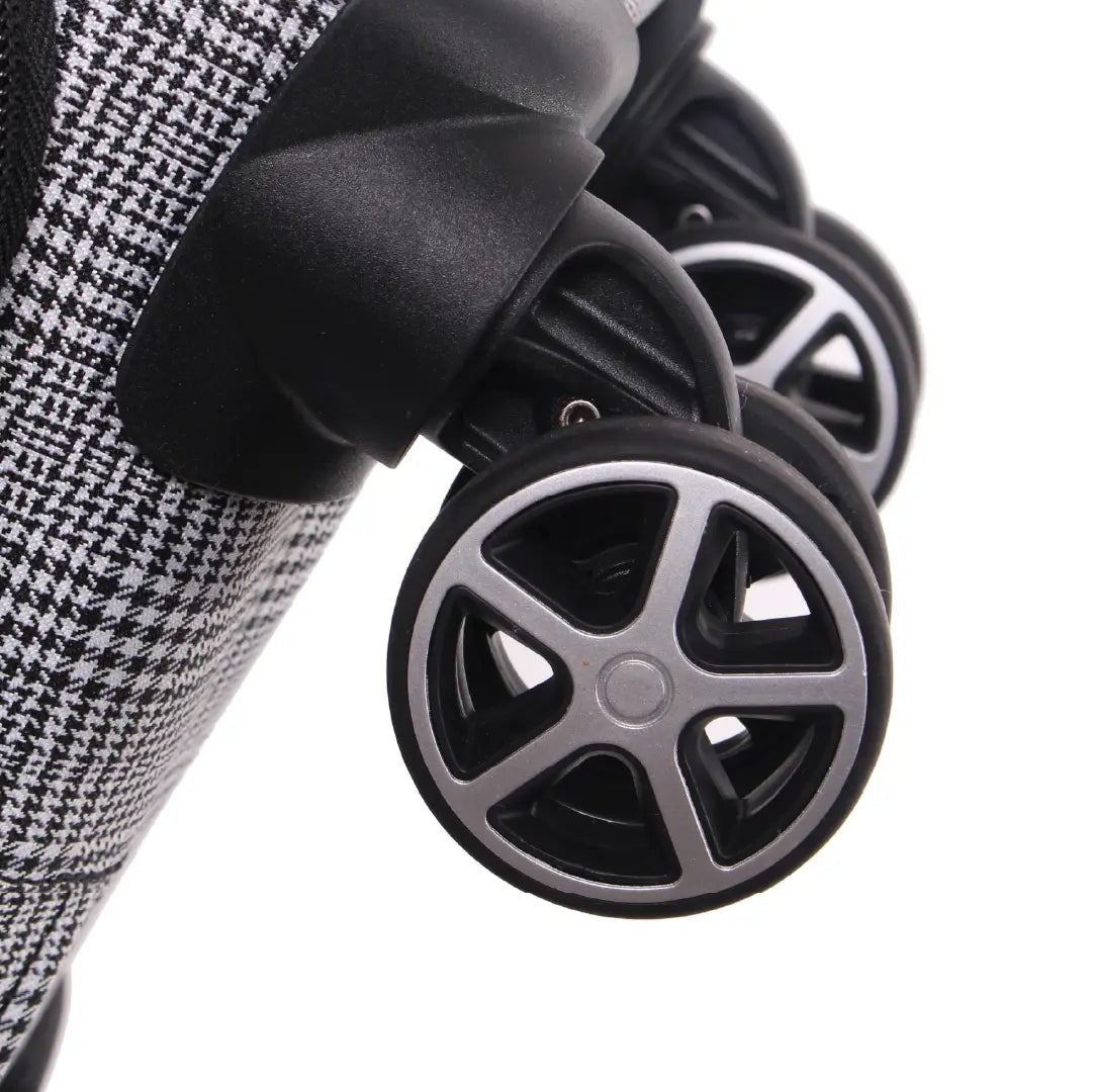 Close-up of a stroller wheel with a checkered fabric background