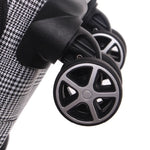 Close-up of a stroller wheel with a checkered fabric background