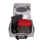 Open suitcase with various items including a red blanket, black bag, and white towel on a white background.