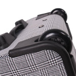 Close-up of a textured suitcase handle and body on a white background