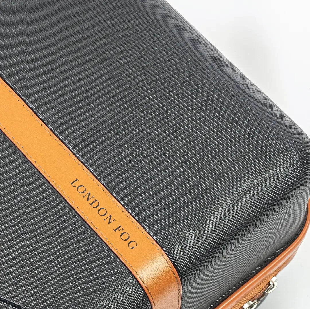 Gray suitcase with brown accent and 'London Fog' branding on a light gray background