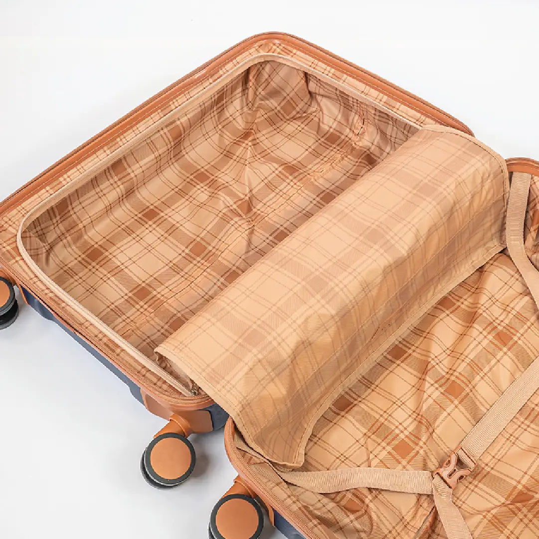Open suitcase with plaid patterned fabric inside and on top