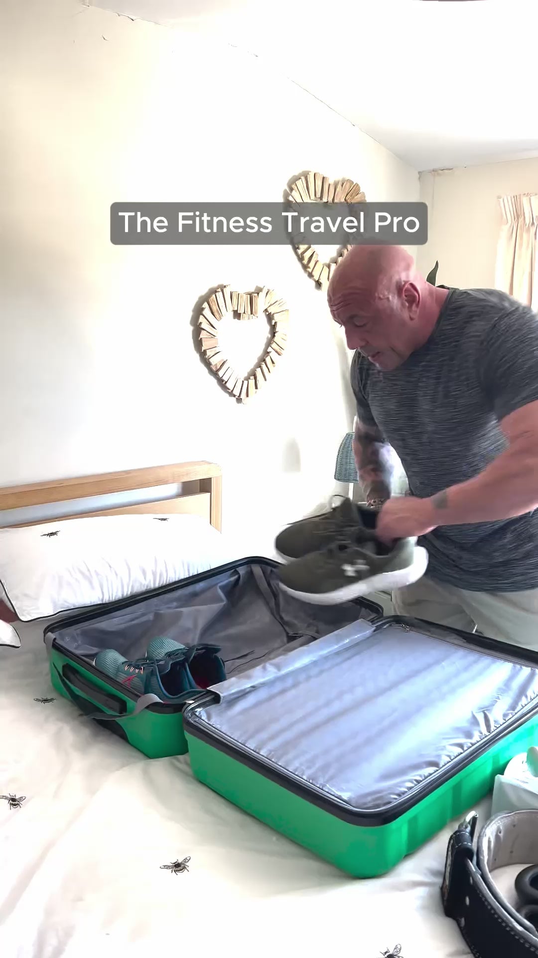 A man packing a medium green suitcase with sports attire and essentials.